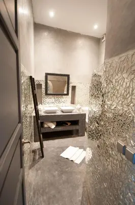 a bathroom with a sink and a mirror at Riad Origines in Marrakech