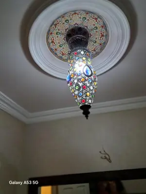 a chandelier hanging from a ceiling in a room at Élégance et authenticité in Marrakech