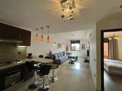 a kitchen and living room with a couch and a table at La maison Majorelle de Marrakech in Marrakech
