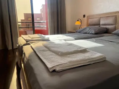 two beds in a hotel room with towels on them at La maison Majorelle de Marrakech in Marrakech