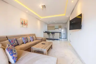 a living room with a couch and a table at Appartement haut standing au centre de Marrakech in Marrakech