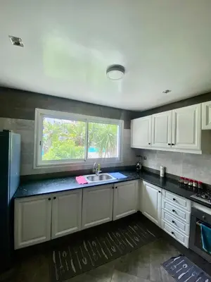 a kitchen with white cabinets and a sink and a window at Apartment in Marrakech equipped and comfortable in Marrakech