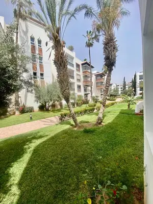 two palm trees in front of a building at Apartment in Marrakech equipped and comfortable in Marrakech