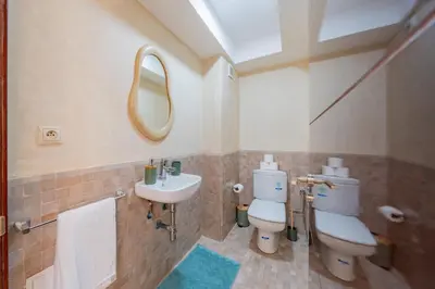 a bathroom with a sink and a toilet and a mirror at Villa Waky Confort & Relax in Marrakech