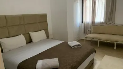 a bedroom with a large bed and a chair at Appartement au cœur de Marrakech in Marrakech