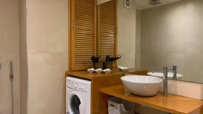 a bathroom with a washing machine and a sink at Appartement au cœur de Marrakech in Marrakech
