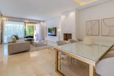 a large living room with a table and chairs at Villa sur golf avec piscine privée chauffée in Marrakech