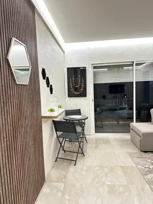 a living room with a table and a couch at Appartement Centre Gare gueliz chic et cosy de Marrakech in Marrakech