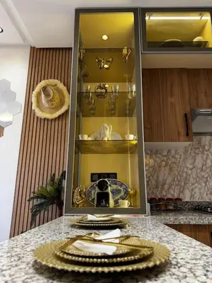 a kitchen counter with a cabinet with plates on it at Appartement confort in Marrakech