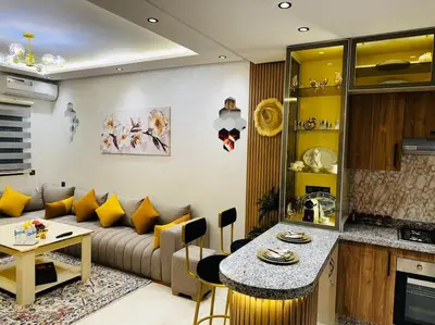 a living room with a couch and a table at Appartement confort in Marrakech