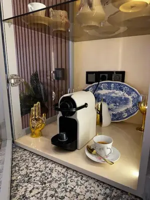a coffee maker on a counter with a cup of coffee at Appartement confort in Marrakech