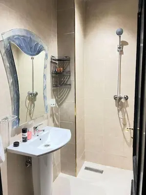 a small bathroom with a sink and a shower at Appartement à Marrakech au cœur de guéliz in Marrakech