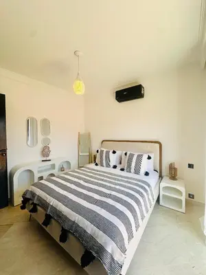 a bedroom with a bed with a black and white striped blanket at Magnifique 1 Room WIFI en plein coeur de GUELIZ in Marrakech