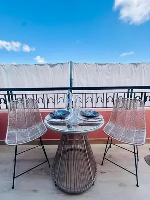 a table and two chairs on a balcony at Magnifique 1 Room WIFI en plein coeur de GUELIZ in Marrakech