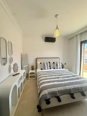a white bedroom with a bed and a window at Magnifique 1 Room WIFI en plein coeur de GUELIZ in Marrakech