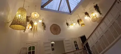 a room with several lights hanging from the ceiling at Riad Kechin Beldi in Marrakech