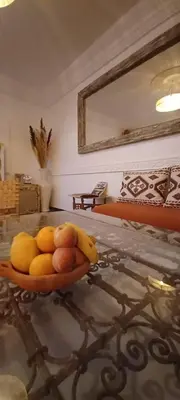 a bowl of fruit on a table in a room at Riad Kechin Beldi in Marrakech