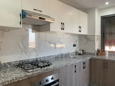 a kitchen with white marble counter tops and a sink at MARRAKECH Palmeraie Gates in Marrakech