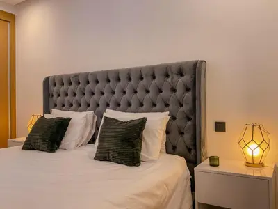 a bedroom with a large bed with a large headboard at MARRAKECH Palmeraie Gates in Marrakech