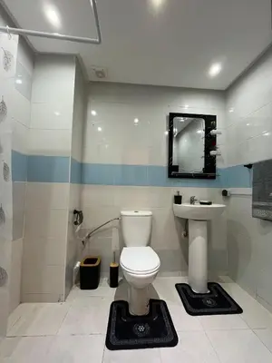 a bathroom with a toilet and a sink at Cozy Apartment Near Airport in Marrakech