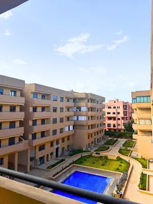 a view of an apartment complex with a swimming pool at La Palmeraie Luxueux avec Piscine et Parking in Marrakech