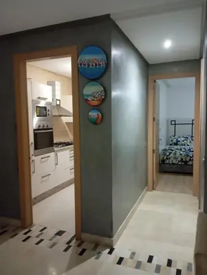 a room with a kitchen and a room with a kitchen at Prestigia appartement in Marrakech