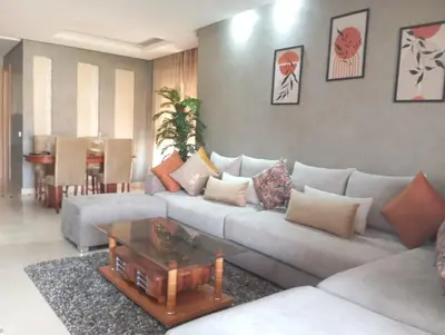 a living room with a couch and a coffee table at Prestigia appartement in Marrakech