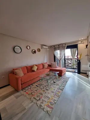 a living room with a red couch and a rug at Shine house in Marrakech