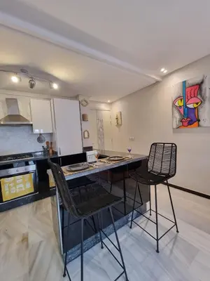 a kitchen with a table and chairs in a room at Shine house in Marrakech