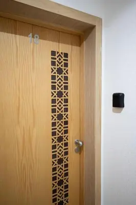 a wooden door with a design on it at Studio moderne à deux pas du coeur de la ville in Marrakech