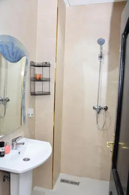 a bathroom with a shower with a sink and a shower at Assala GUÉLIZ in Marrakech