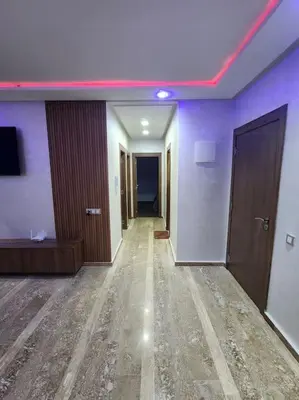 a hallway of a hotel with purple walls and wooden floors at Évasion élégante à Marrakech in Marrakech