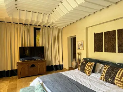 a bedroom with a bed and a flat screen tv at Villa Ania in Marrakech
