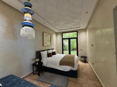 a bedroom with a bed and a chandelier at Villa Ania in Marrakech