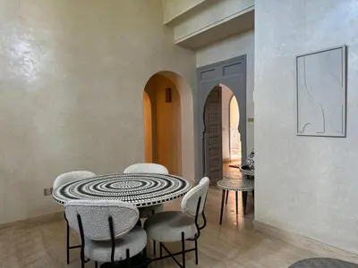 a dining room with a table and chairs at Villa Ania in Marrakech