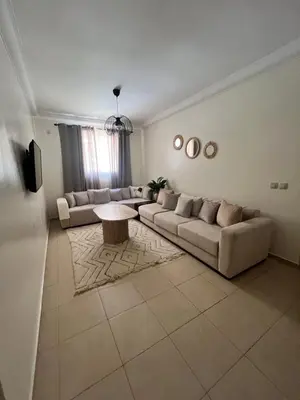 a living room with couches and a coffee table at Appartement Marrakech aéroport Menara airport Gueliz in Marrakech