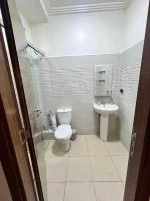 a bathroom with a toilet and a sink at Appartement Marrakech aéroport Menara airport Gueliz in Marrakech