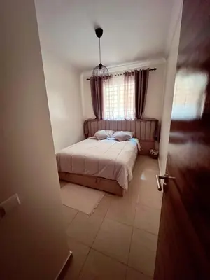 a small bedroom with a bed and a window at Appartement Marrakech aéroport Menara airport Gueliz in Marrakech