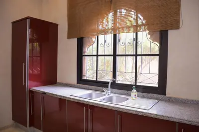 a kitchen with a sink and a window at Capstay Riad Villa in secure residence in Marrakech