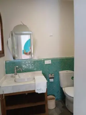 a bathroom with a sink and a toilet and a mirror at Appartement Palmeraie avec terrasse in Marrakech