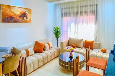 a living room with a couch and a table at 17 - Top Location, NEUF, piscine & Comfort in Marrakech