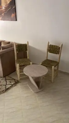 a living room with two chairs and a table and a couch at Familial Cosy Appart in Marrakech