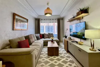 a living room with a couch and a tv at Apartment in Centre of Marrakech in Marrakech