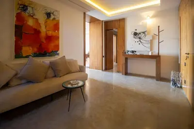 a living room with a couch and a table at HM50 l Villa en front de golf piscine & jacuzzi in Marrakech