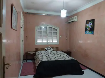 a bedroom with a bed and a window at Au cœur de Marrakech in Marrakech