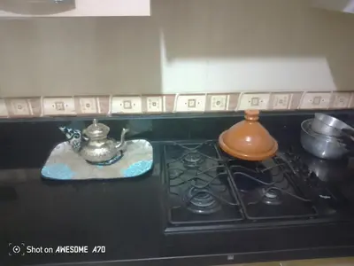 a stove with a tea pot on top of it at Au cœur de Marrakech in Marrakech