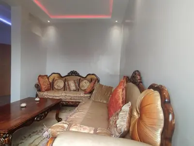 a living room with a couch and a table at Tout est Nouveau et Propre,au Centre marrakech in Marrakech