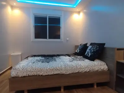 a bedroom with a bed with a blue light on it at Tout est Nouveau et Propre,au Centre marrakech in Marrakech