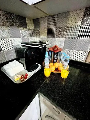 a kitchen counter with a coffee maker and some oranges at Villa à marrakech avec piscine in Marrakech