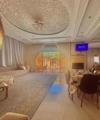 a living room with a couch and a table at Villa à marrakech avec piscine in Marrakech
